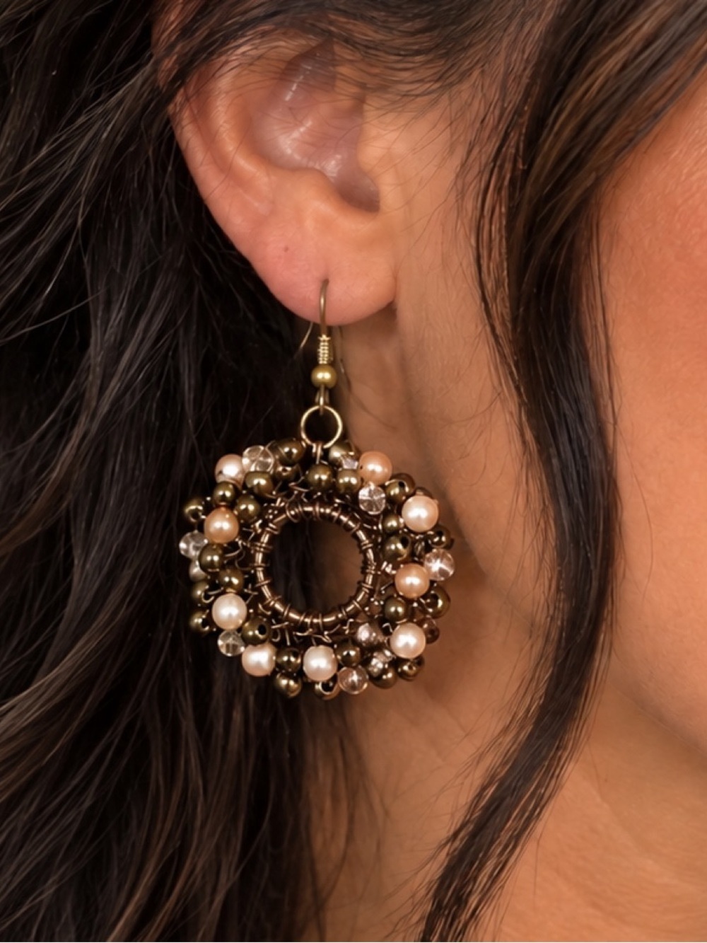 Beaded wire hoop earrings featuring brown, metallic, and pearl-like beads